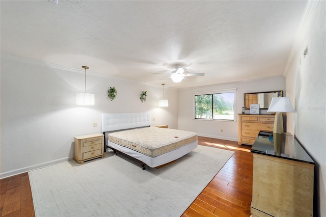 6015 SW 36th Way, Gainesville, FL 32608 - bedroom with light wood-style floors, baseboards, ornamental molding, and ceiling fan