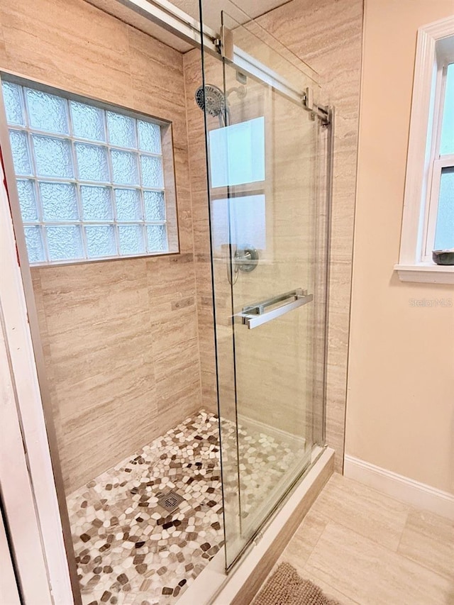 1425 S Central Ave, Flagler Beach, FL 32136 - bathroom featuring a stall shower, baseboards, and tile patterned floors