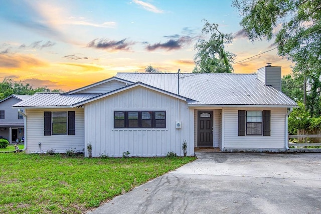 11274 71st Dr, Live Oak, FL 32060 - view of front facade with metal roof, a chimney, and driveway