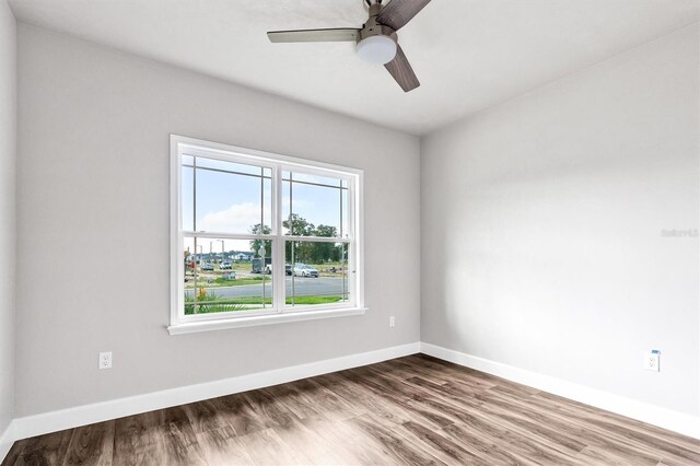 6669 SW 10th Ln, Gainesville, FL 32607 - empty room with ceiling fan, wood finished floors, and baseboards