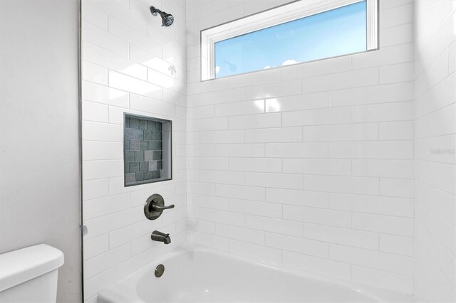 6669 SW 10th Ln, Gainesville, FL 32607 - bathroom featuring toilet and shower / bathtub combination