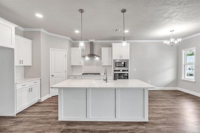 6669 SW 10th Ln, Gainesville, FL 32607 - kitchen with wall chimney range hood, stainless steel appliances, ornamental molding, light countertops, and white cabinets