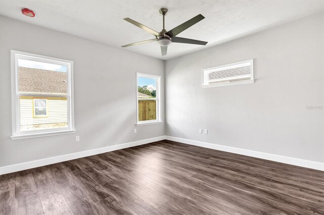 6669 SW 10th Ln, Gainesville, FL 32607 - spare room featuring dark wood-type flooring, baseboards, and a ceiling fan