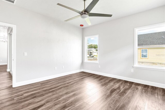 6669 SW 10th Ln, Gainesville, FL 32607 - empty room featuring dark wood-style flooring, a ceiling fan, and baseboards