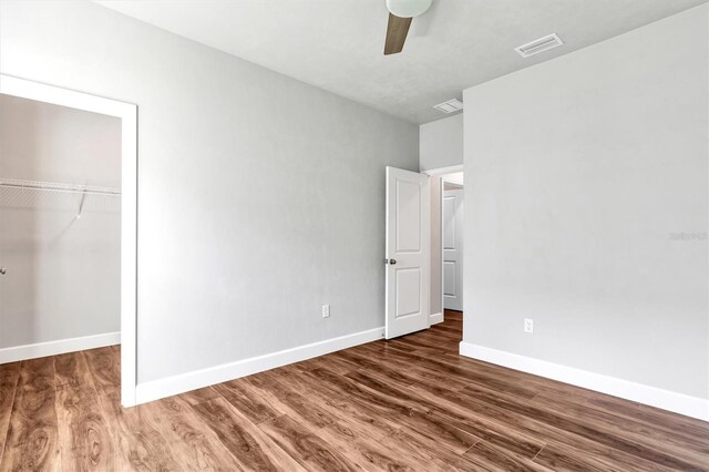 6669 SW 10th Ln, Gainesville, FL 32607 - unfurnished bedroom with wood finished floors, baseboards, a closet, and ceiling fan