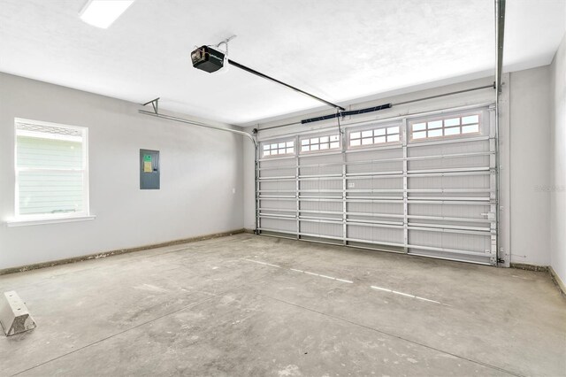 6669 SW 10th Ln, Gainesville, FL 32607 - garage with electric panel, a garage door opener, and baseboards