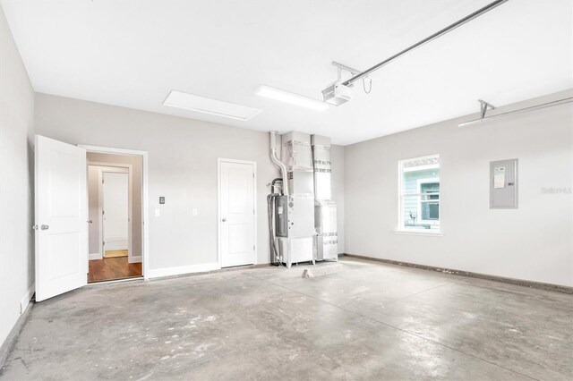 6669 SW 10th Ln, Gainesville, FL 32607 - garage featuring a garage door opener, electric panel, and baseboards