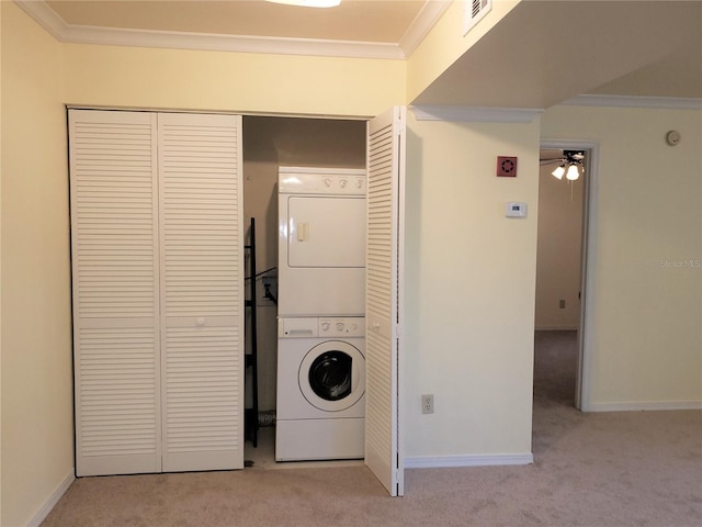 2360 SW Archer Rd Unit 404, Gainesville, FL 32608 - laundry room with stacked washer and clothes dryer, carpet flooring, ornamental molding, baseboards, and a ceiling fan