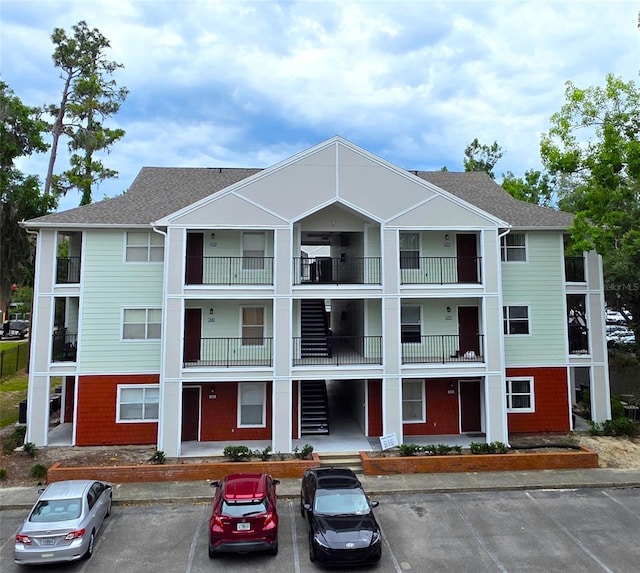 2360 SW Archer Rd Unit 404, Gainesville, FL 32608 - view of building exterior with uncovered parking