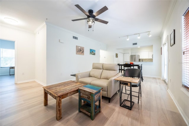 4850 SW 91st Ter Unit P201, Gainesville, FL 32608 - living area featuring ornamental molding, light wood finished floors, a ceiling fan, baseboards, and plenty of natural light
