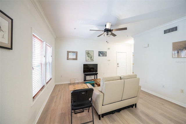 4850 SW 91st Ter Unit P201, Gainesville, FL 32608 - living room featuring light wood-style flooring, a ceiling fan, baseboards, and crown molding