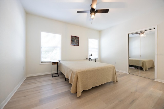 4850 SW 91st Ter Unit P201, Gainesville, FL 32608 - bedroom featuring light wood-style floors, multiple windows, and baseboards