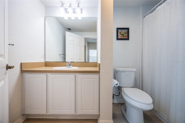 4850 SW 91st Ter Unit P201, Gainesville, FL 32608 - bathroom with vanity, toilet, baseboards, and curtained shower