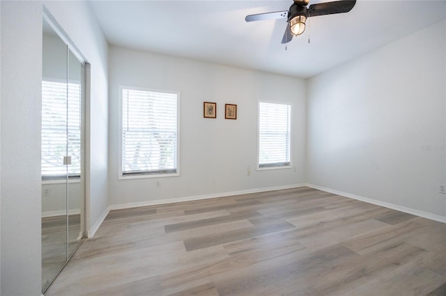 4850 SW 91st Ter Unit P201, Gainesville, FL 32608 - spare room with healthy amount of natural light, ceiling fan, light wood-type flooring, and baseboards