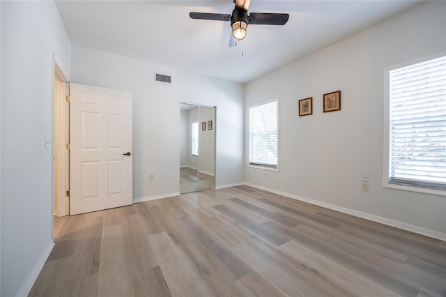 4850 SW 91st Ter Unit P201, Gainesville, FL 32608 - unfurnished bedroom featuring light wood-type flooring, baseboards, and a ceiling fan