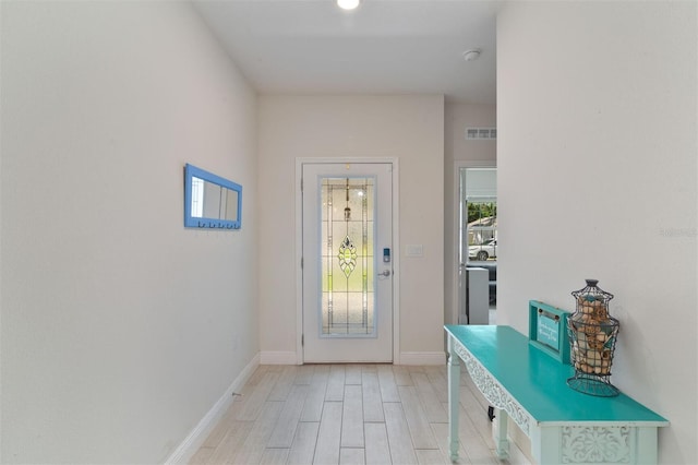 24624 NW 7th Ln, Newberry, FL 32669 - doorway with light wood finished floors and baseboards