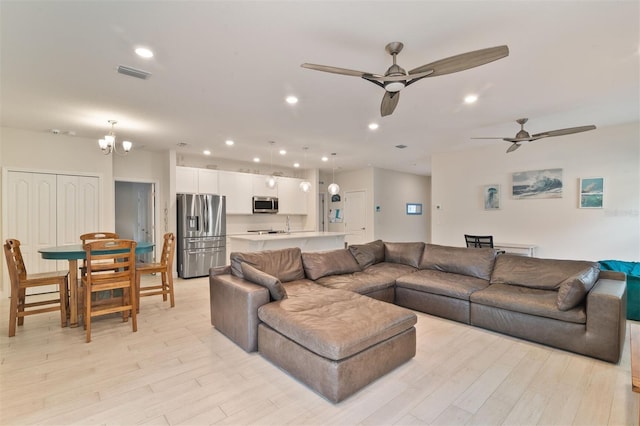 24624 NW 7th Ln, Newberry, FL 32669 - living room with light wood-style flooring, ceiling fan, recessed lighting, and a chandelier