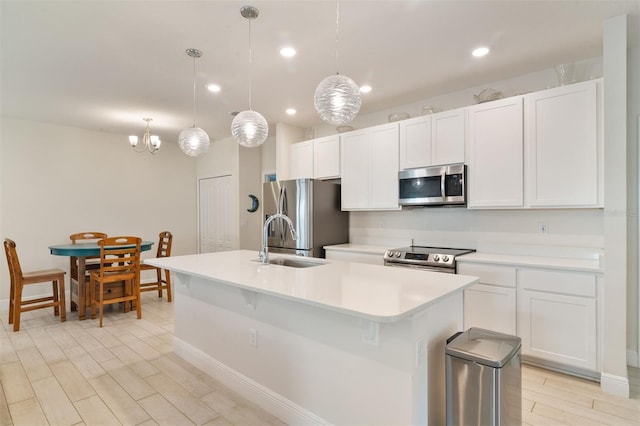 24624 NW 7th Ln, Newberry, FL 32669 - kitchen featuring appliances with stainless steel finishes, a sink, a center island with sink, white cabinets, and recessed lighting