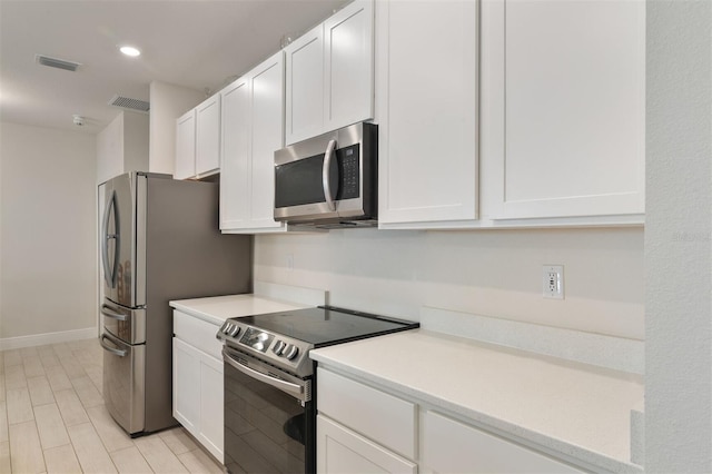 24624 NW 7th Ln, Newberry, FL 32669 - kitchen featuring appliances with stainless steel finishes, white cabinetry, light countertops, and recessed lighting