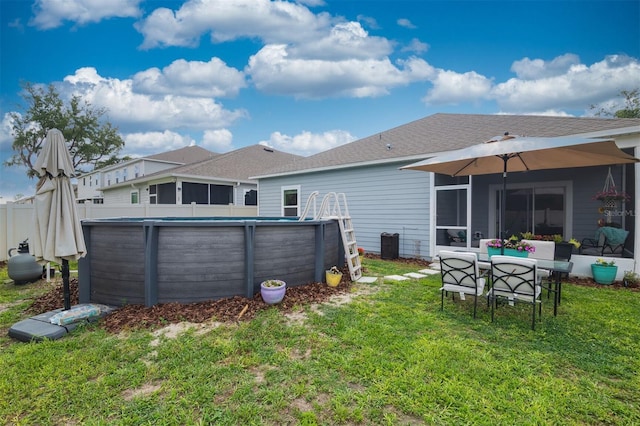 24624 NW 7th Ln, Newberry, FL 32669 - back of house featuring a yard, a sunroom, and roof with shingles