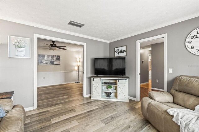 2204 Krista Ln, Brandon, FL 33511 - living room with wood finished floors, a ceiling fan, baseboards, and ornamental molding