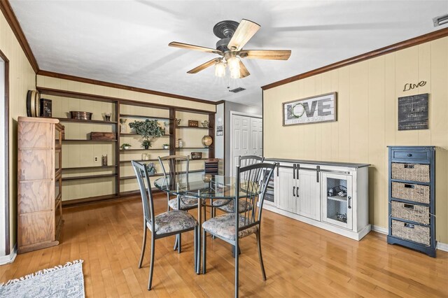 2204 Krista Ln, Brandon, FL 33511 - dining room featuring wood-type flooring, ceiling fan, crown molding, baseboards, and wood walls