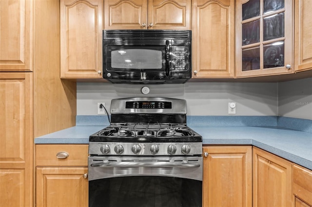 2204 Krista Ln, Brandon, FL 33511 - kitchen featuring stainless steel gas range oven, black microwave, light brown cabinetry, light countertops, and glass insert cabinets