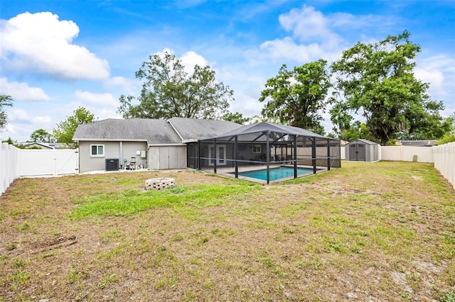 2204 Krista Ln, Brandon, FL 33511 - back of property with a gate, a patio area, central AC unit, and a lanai