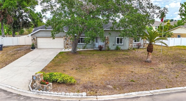 2204 Krista Ln, Brandon, FL 33511 - view of property hidden behind natural elements featuring an attached garage, stucco siding, and concrete driveway