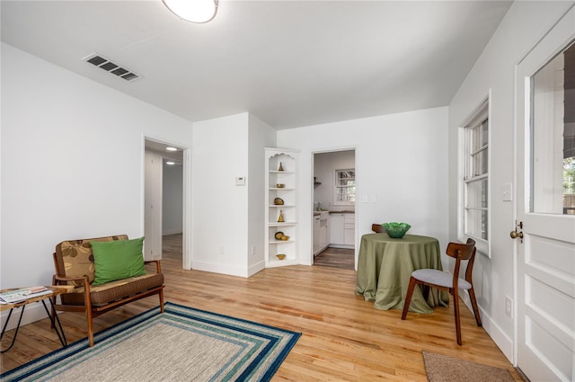 1617 NE 8th St, Gainesville, FL 32609 - sitting room with light wood-style flooring, baseboards, and built in features