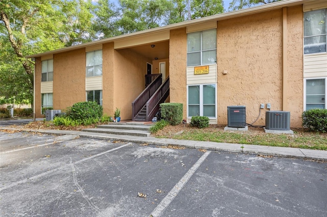 1810 NW 23rd Blvd Unit 203, Gainesville, FL 32605 - view of building exterior with central air condition unit and uncovered parking