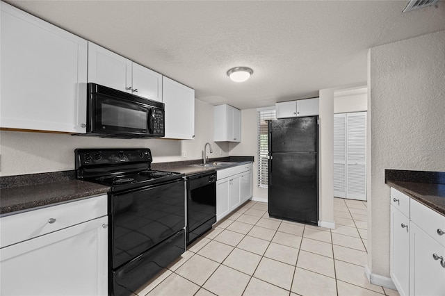 1810 NW 23rd Blvd Unit 203, Gainesville, FL 32605 - kitchen with black appliances, dark countertops, a sink, a textured ceiling, and a textured wall
