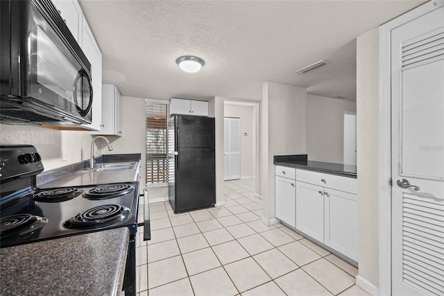 1810 NW 23rd Blvd Unit 203, Gainesville, FL 32605 - kitchen with black appliances, a sink, white cabinets, light tile patterned floors, and a textured ceiling
