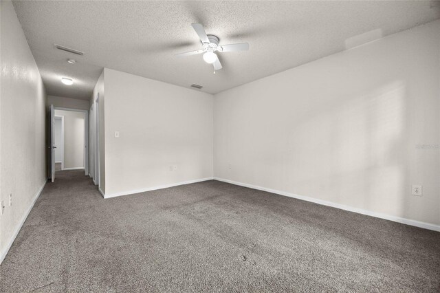 1810 NW 23rd Blvd Unit 203, Gainesville, FL 32605 - empty room featuring a ceiling fan, a textured ceiling, carpet floors, and baseboards
