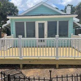 915 S Broadway Unit Ab, Englewood, FL 34223 - rear view of house with a chimney and a wooden deck