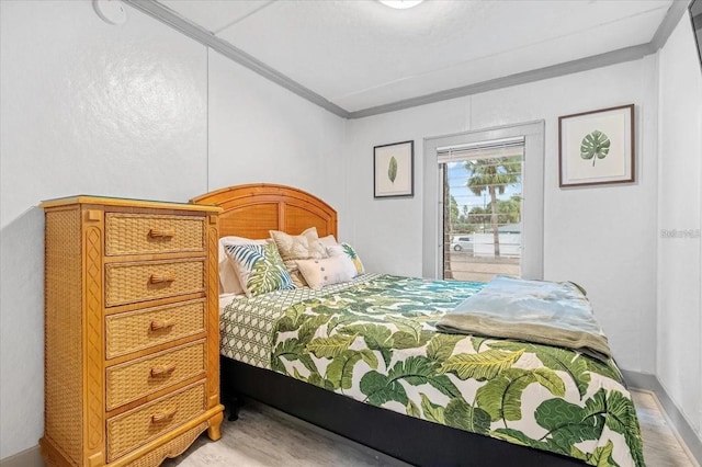 915 S Broadway Unit Ab, Englewood, FL 34223 - bedroom featuring crown molding, access to exterior, wood finished floors, and baseboards