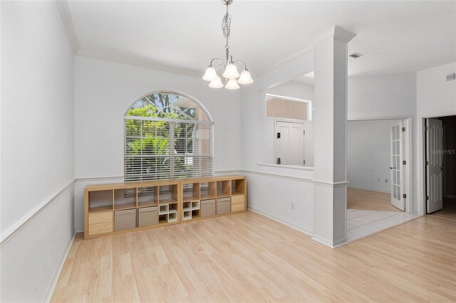 6806 NW 105th Ave, Alachua, FL 32615 - unfurnished dining area featuring wood finished floors, a chandelier, baseboards, and crown molding