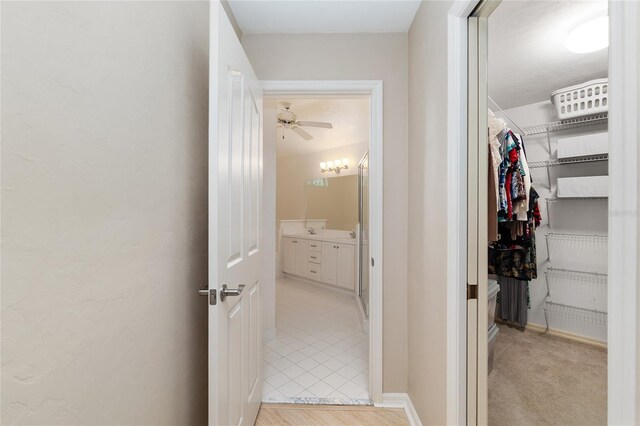 6806 NW 105th Ave, Alachua, FL 32615 - corridor with light tile patterned floors and a sink