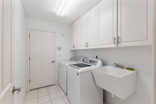 6806 NW 105th Ave, Alachua, FL 32615 - laundry area with cabinet space, separate washer and dryer, and light tile patterned floors