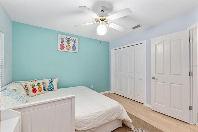 6806 NW 105th Ave, Alachua, FL 32615 - bedroom with light wood-style flooring, a closet, baseboards, and ceiling fan