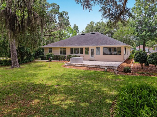 6806 NW 105th Ave, Alachua, FL 32615 - back of property with a yard and a patio area