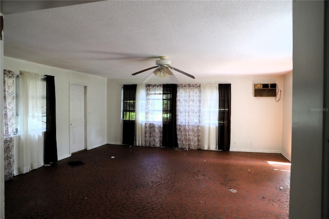 21514 SE 69th Ave, Hawthorne, FL 32640 - spare room featuring ceiling fan, baseboards, a wall mounted AC, and a textured ceiling