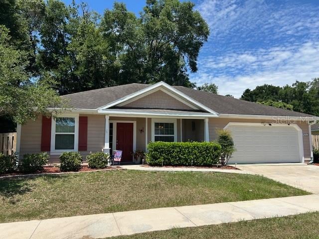 15628 NW 137th Way, Alachua, FL 32615 - ranch-style home featuring an attached garage, a front lawn, and concrete driveway
