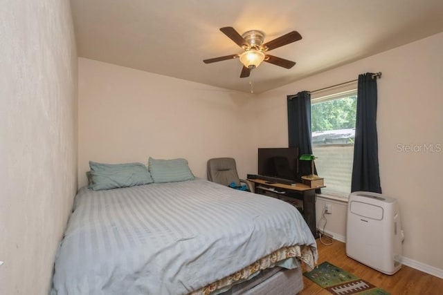 15628 NW 137th Way, Alachua, FL 32615 - bedroom featuring light wood-style flooring, baseboards, and ceiling fan