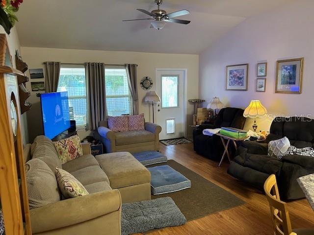 15628 NW 137th Way, Alachua, FL 32615 - living area featuring lofted ceiling, a ceiling fan, and wood finished floors