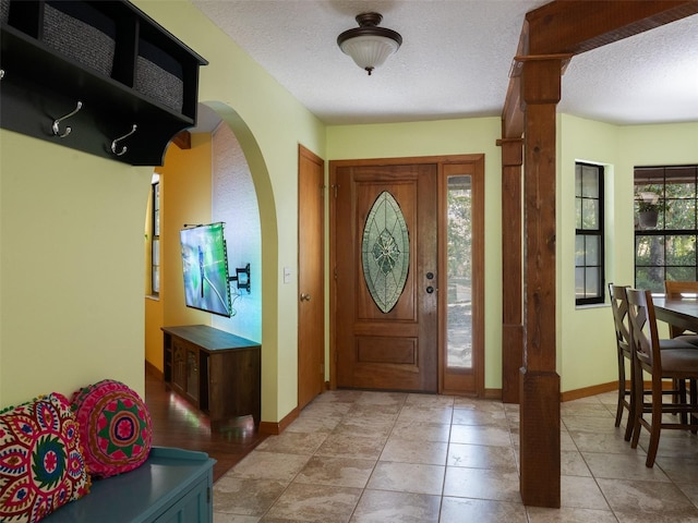 113 Myrtlewood Point Rd, East Palatka, FL 32131 - foyer entrance with baseboards, arched walkways, and a textured ceiling