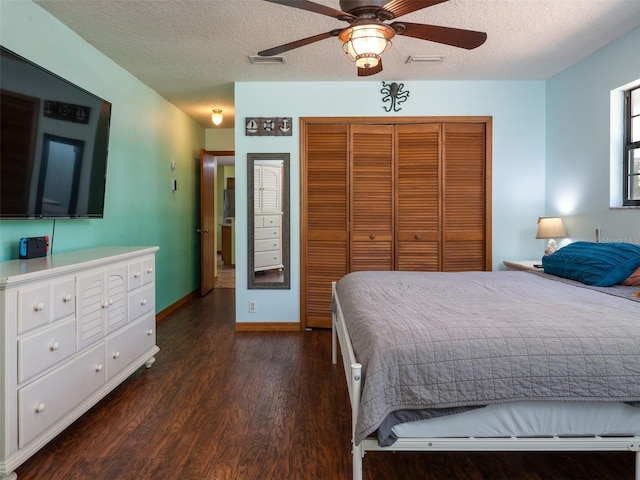 113 Myrtlewood Point Rd, East Palatka, FL 32131 - bedroom with a closet, dark wood-type flooring, a textured ceiling, ceiling fan, and baseboards