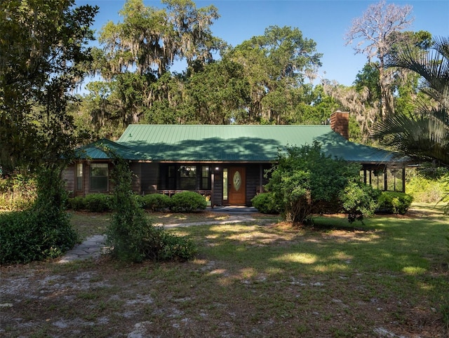 113 Myrtlewood Point Rd, East Palatka, FL 32131 - view of front of home featuring a front yard, a chimney, and metal roof