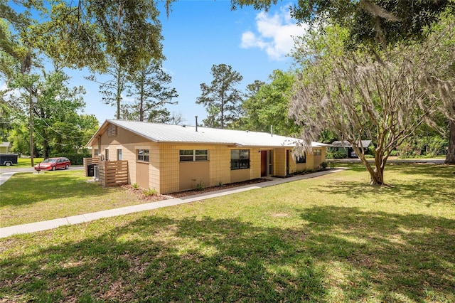 915 NW 40th Ave, Gainesville, Fl, FL 32605 - view of front of property with a front lawn and metal roof