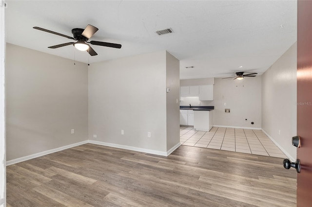 915 NW 40th Ave, Gainesville, Fl, FL 32605 - empty room featuring ceiling fan, light wood-style floors, and baseboards